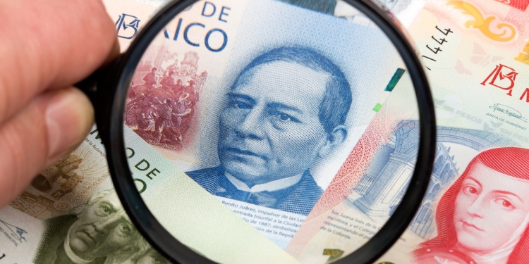 Mexican banknotes under a magnifying glass