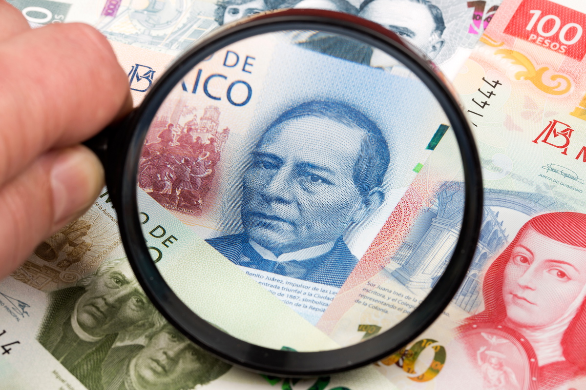 Mexican banknotes under a magnifying glass