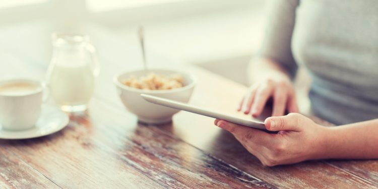 Browsing online at breakfast table