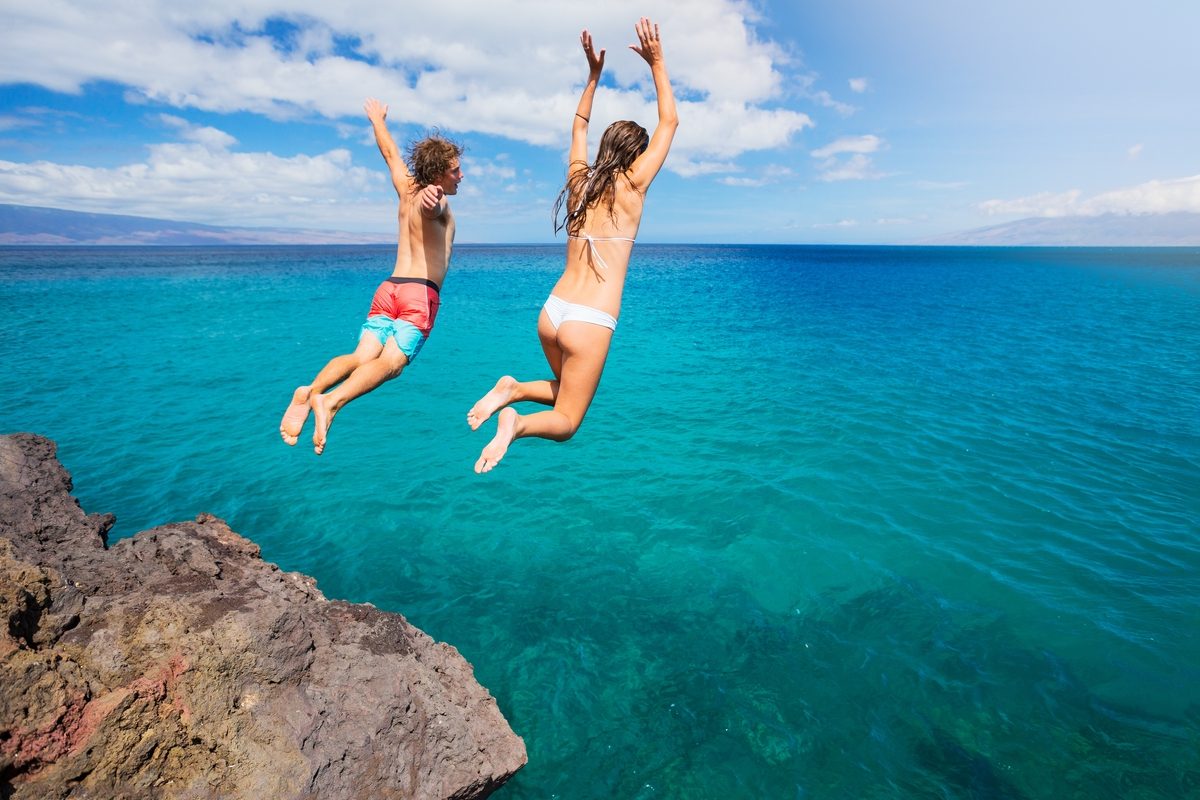 Summertime Couple Jumping into Water