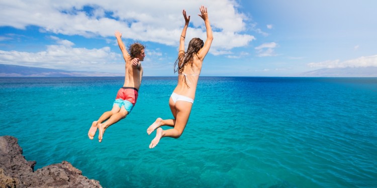 Summertime Couple Jumping into Water