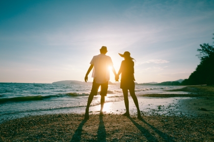Romantic couple on the beach at sunset