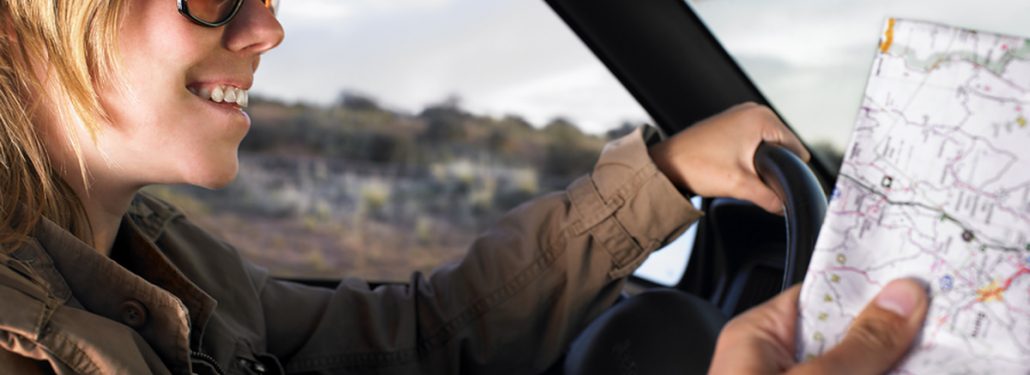 Couple driving in car with map