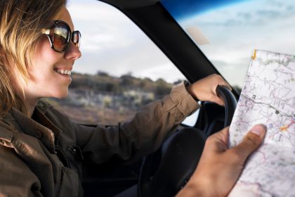 Couple driving in car with map