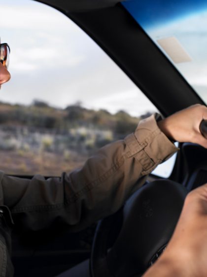 Couple driving in car with map