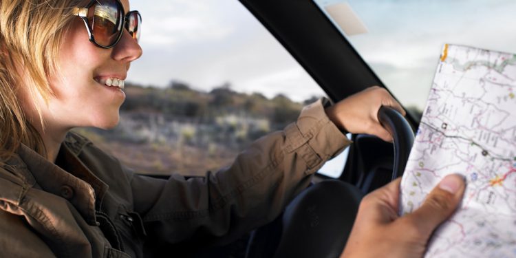 Couple driving in car with map