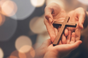 Easter Cross held in hands