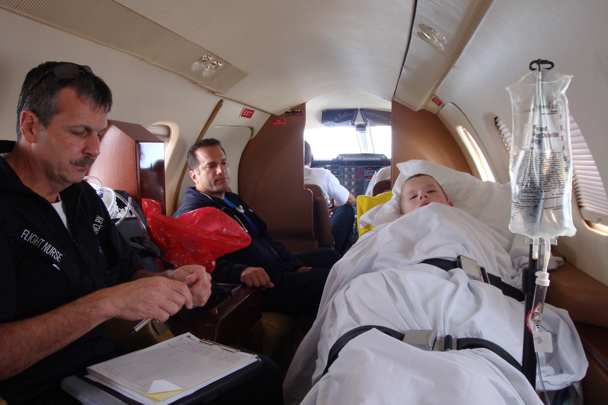 Medical evacuation team and young patient in-flight