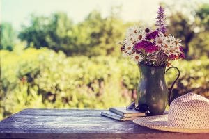 Flowers and vase on a table in the countryside