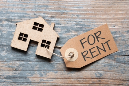 House with a for rent label attached
