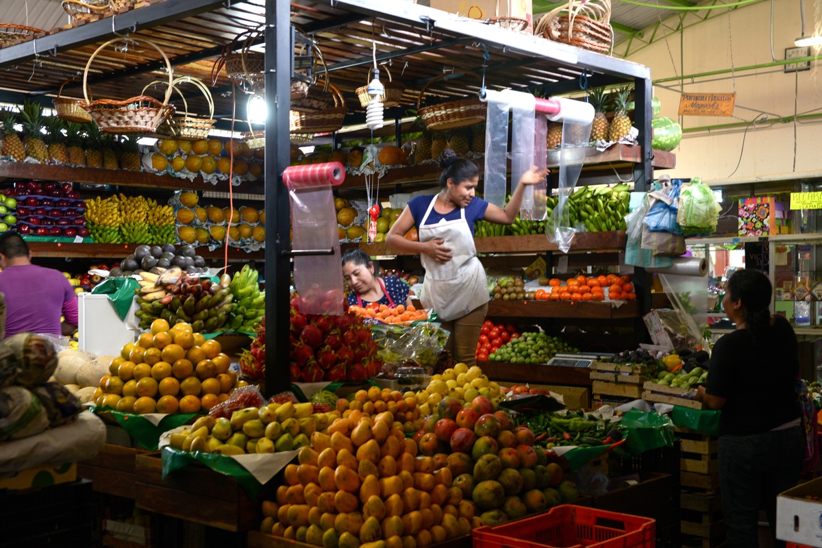 Fruit Seller in Action, Oaxaca Mexico, by Anna Bruce