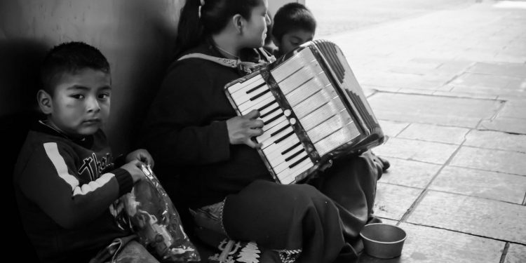 Family playing accordion for tips in Mexico City. Mundial Photo