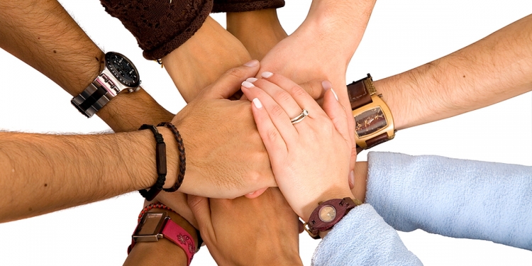 Group of people joining hands