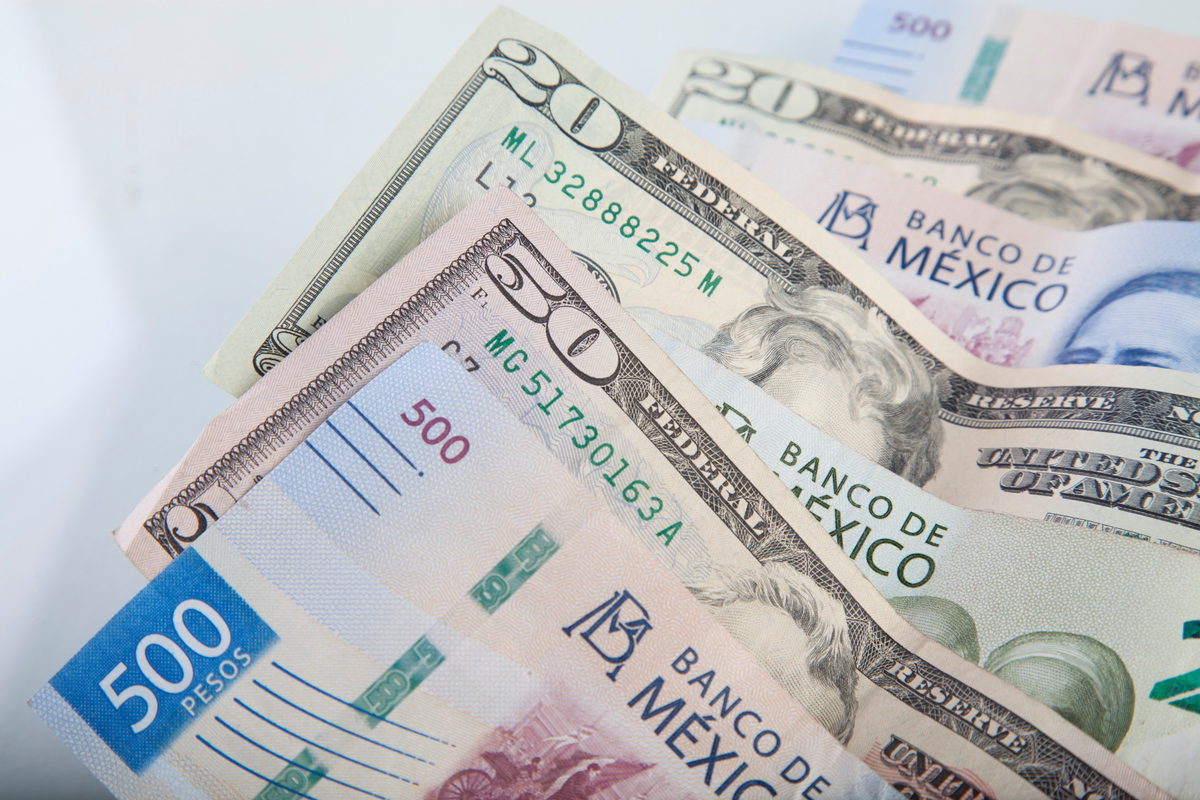 Mexican peso and US dollar banknotes interwoven together