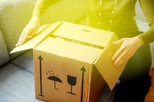 Person opening a moving box to empty it