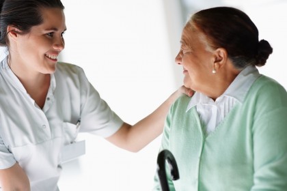 Nurse assisting an elderly lady