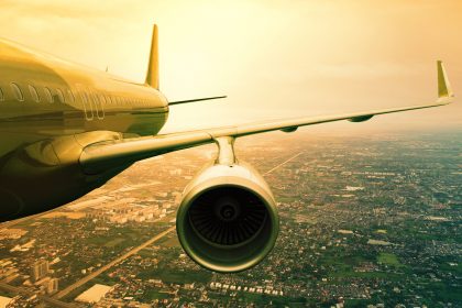 A passenger plane flying over a city