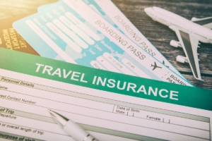 Insurance application form, boarding pass and airplane