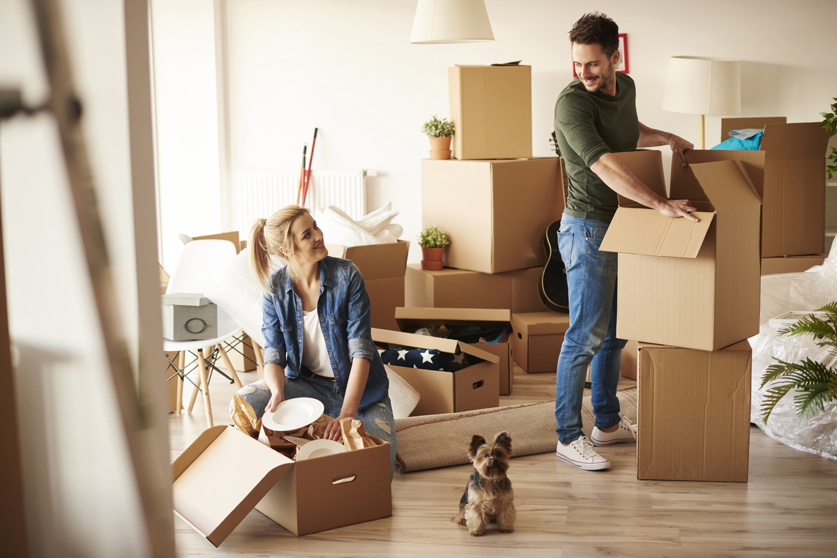 Couple unpacking boxes in a new home