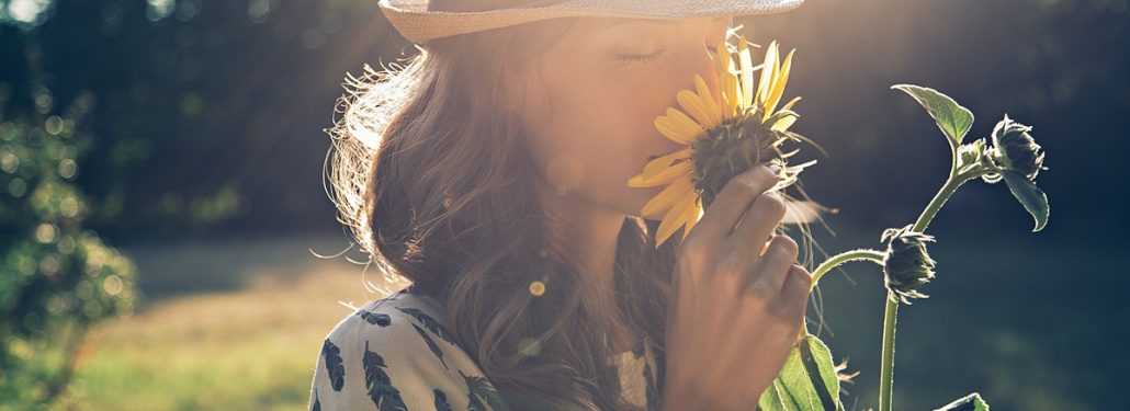 Woman Smelling Flowers