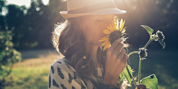 Woman Smelling Flowers